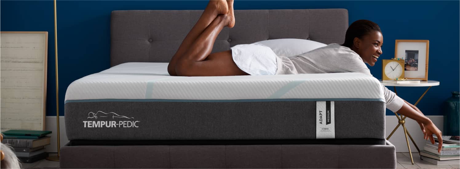 Woman laying on a Tempur-Pedic® mattress.